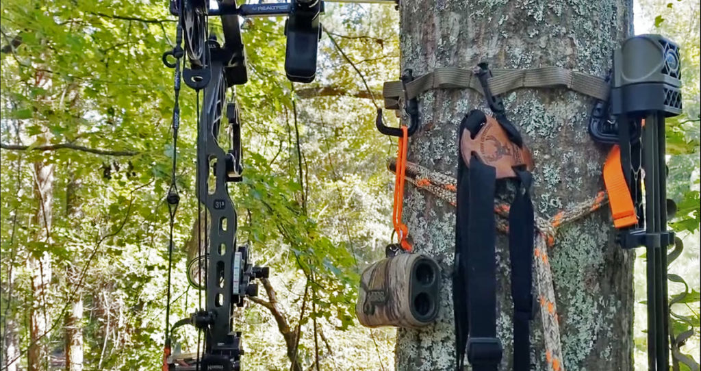 Several saddle hunting accessories hanging from a gear strap.