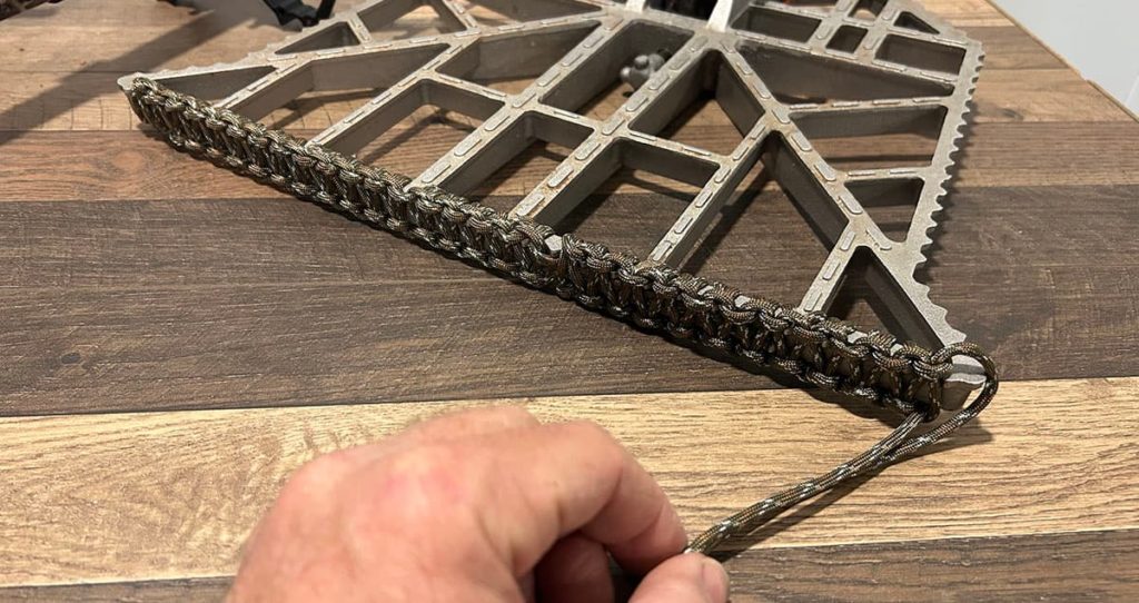 Paracord wrapped around the edge of a saddle hunting platform using a cobra weave.